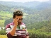 a man in a maroon and white striped shirt is talking on a cell phone